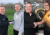 Sophia Kozmevski and Charlotte Hall shake hands with Coach John O'Brien.