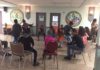 Students sit in a circle for a workshop