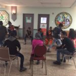 Students sit in a circle for a workshop