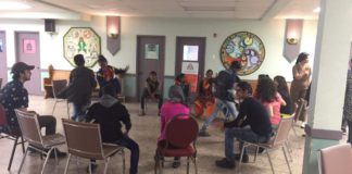 Students sit in a circle for a workshop