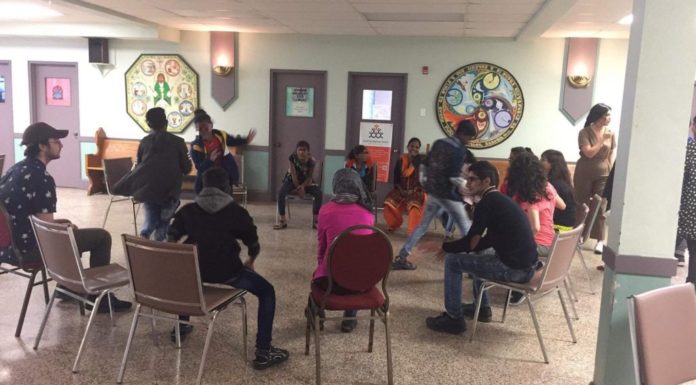 Students sit in a circle for a workshop