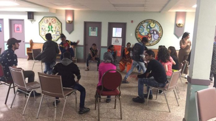 Students sit in a circle for a workshop